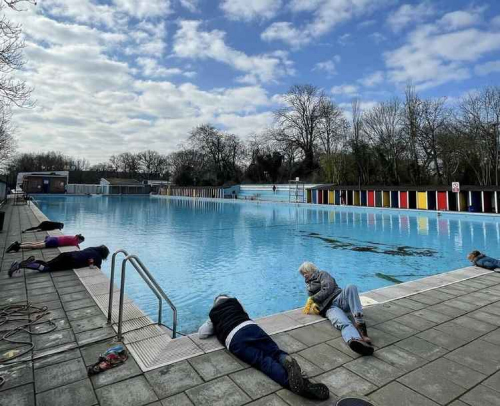 @slsclido (Instagram) | Volunteers scrub Tooting Bec Lido in preparation for reopening