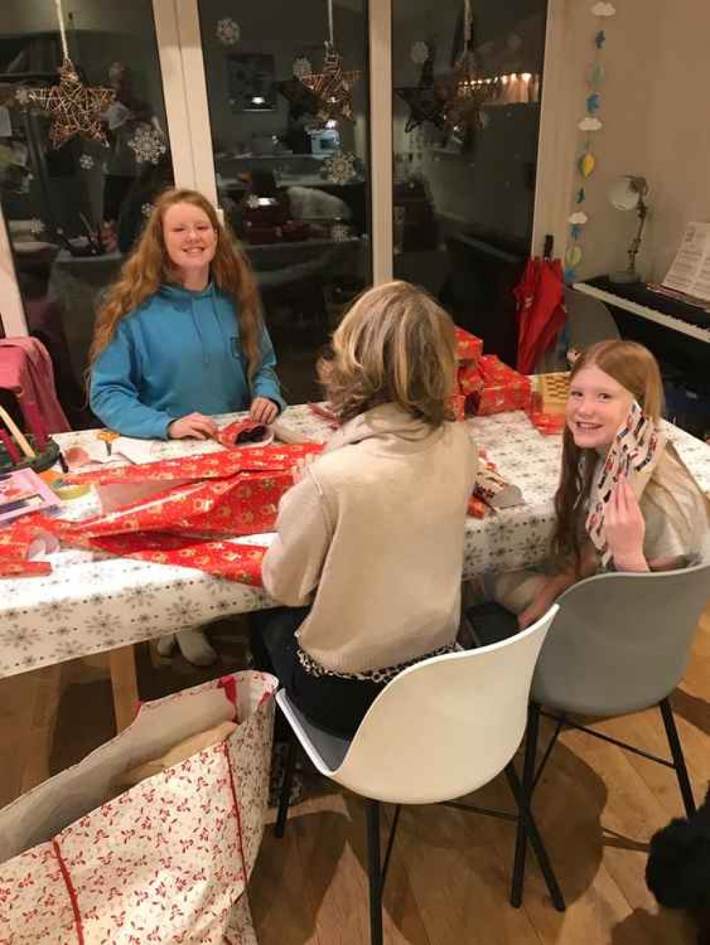 Volunteers wrap presents