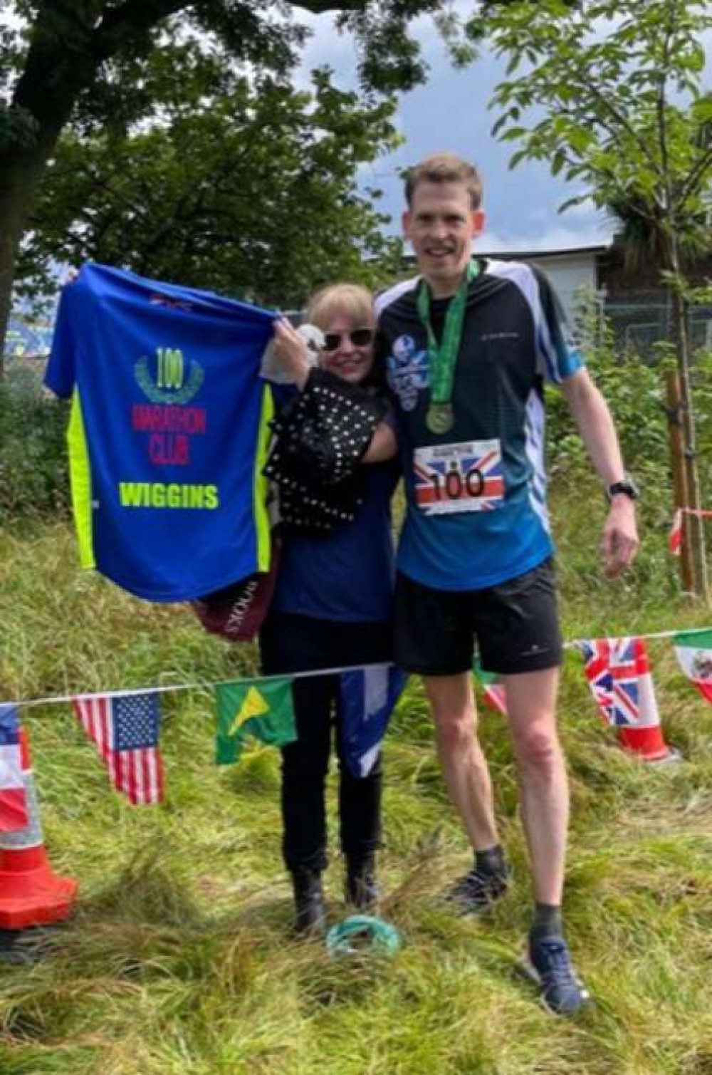 Michael's wife Fiona handing over his 100 club t-shirt