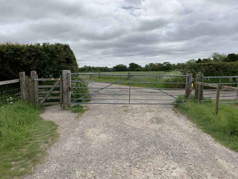 After this large metal gate, turn right, going up a lane with a house on the left