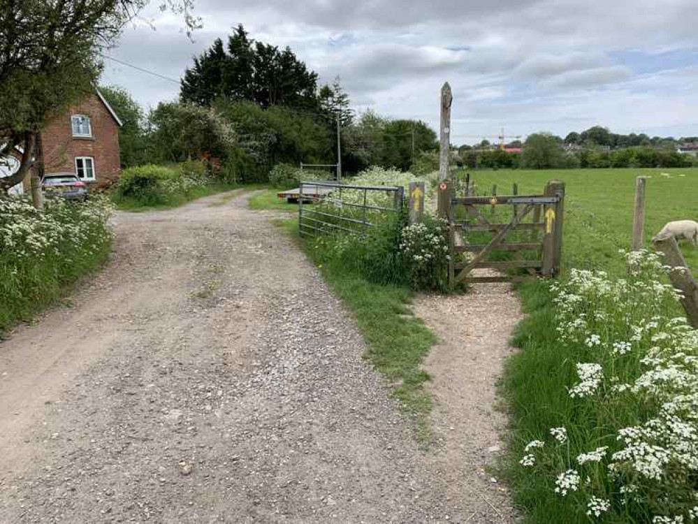 Take the footpath to the right, opposite the house