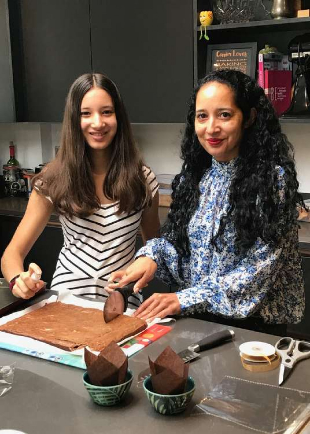 Poppy and Carim baking in the Kitchen to give some birthday moments of joy to older neighbours in Kew.