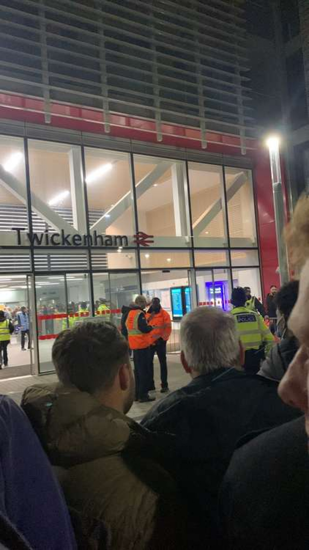 Workers at the station trying to contain the crowds.