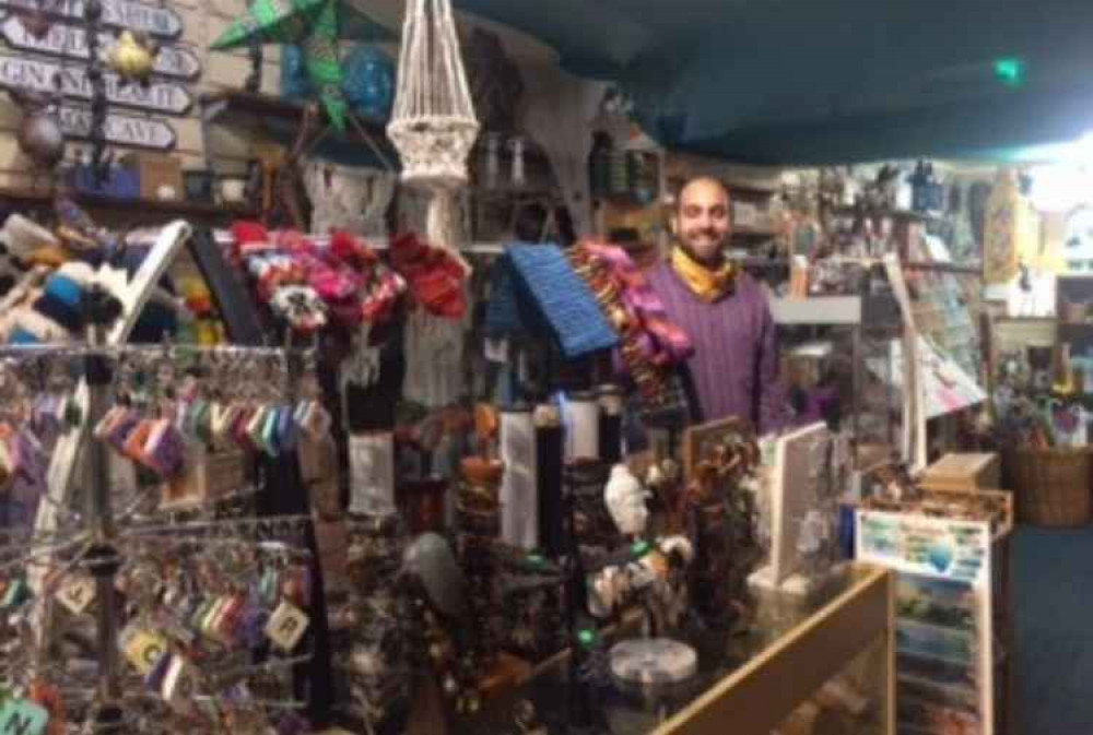 Andy surrounded by colourful, ethnic, artisan products in his shop Curios