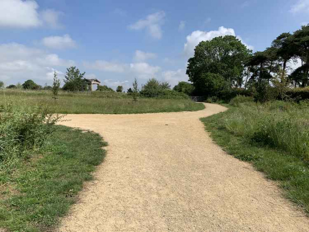 At the T-junction, take the path to the right to go through a metal gate