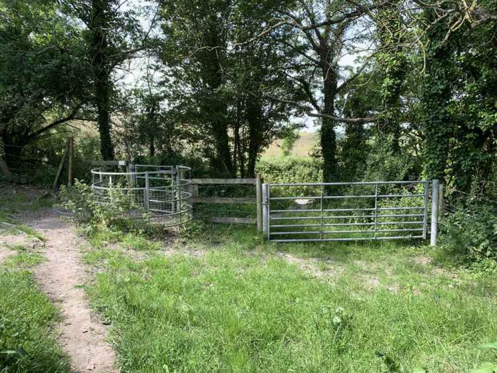 Follow the path to the end and go out the gate onto a road