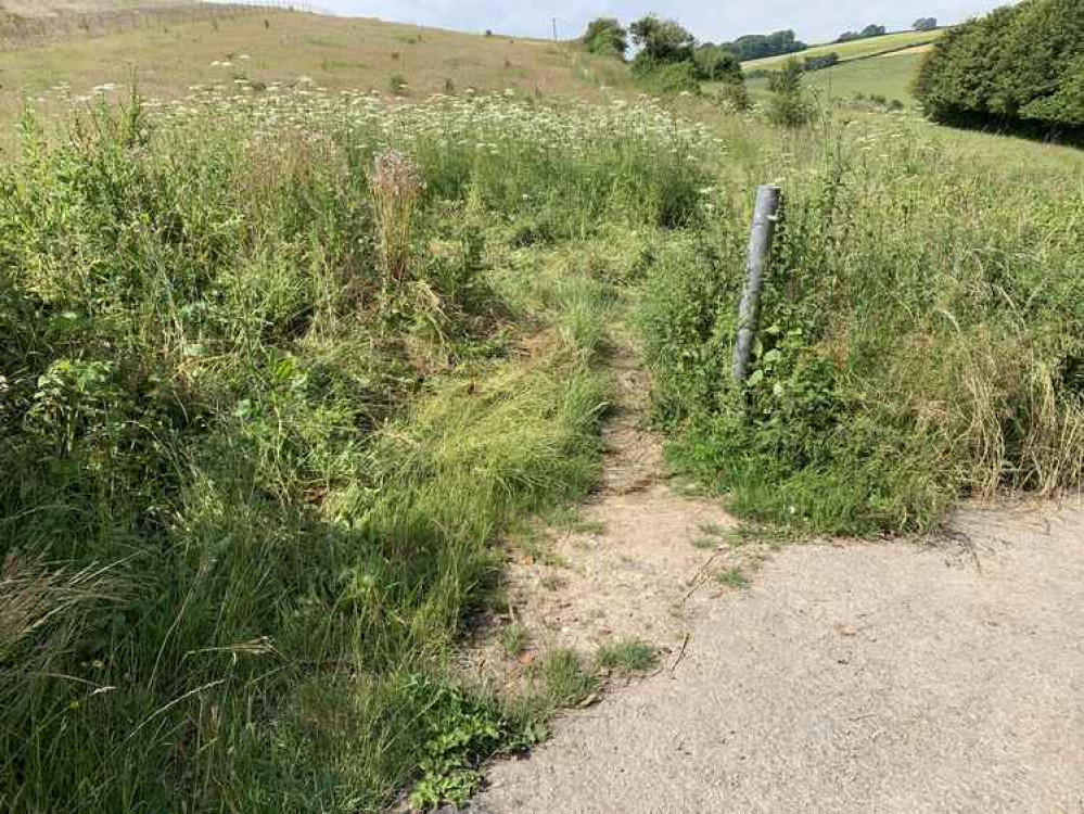 On the opposite side of the road and just down to the right, there is a footpath, go down there