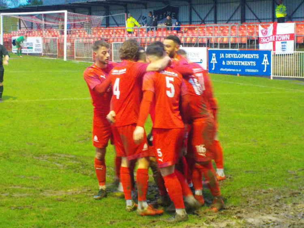 Celebrating the second goal showed how waterlogged the pitch had become