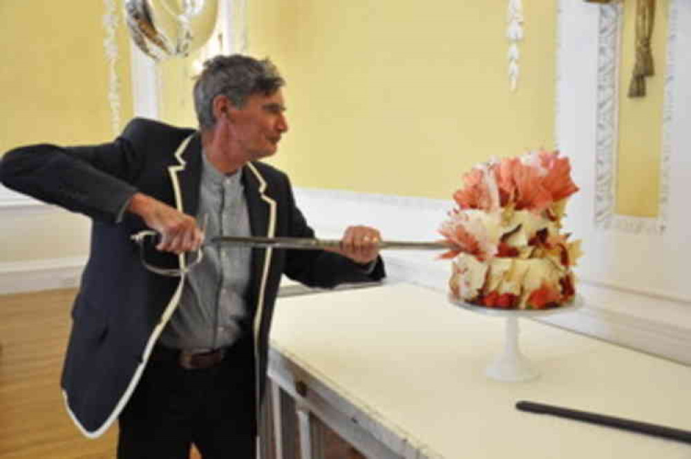 Michael cutting his cake on his 80th birthday