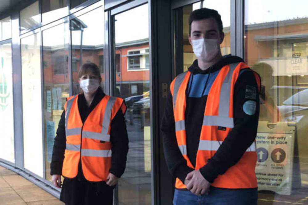 Josh and Mel from the team at FMP helping patients arriving at one of the vaccination clinics held at the practice