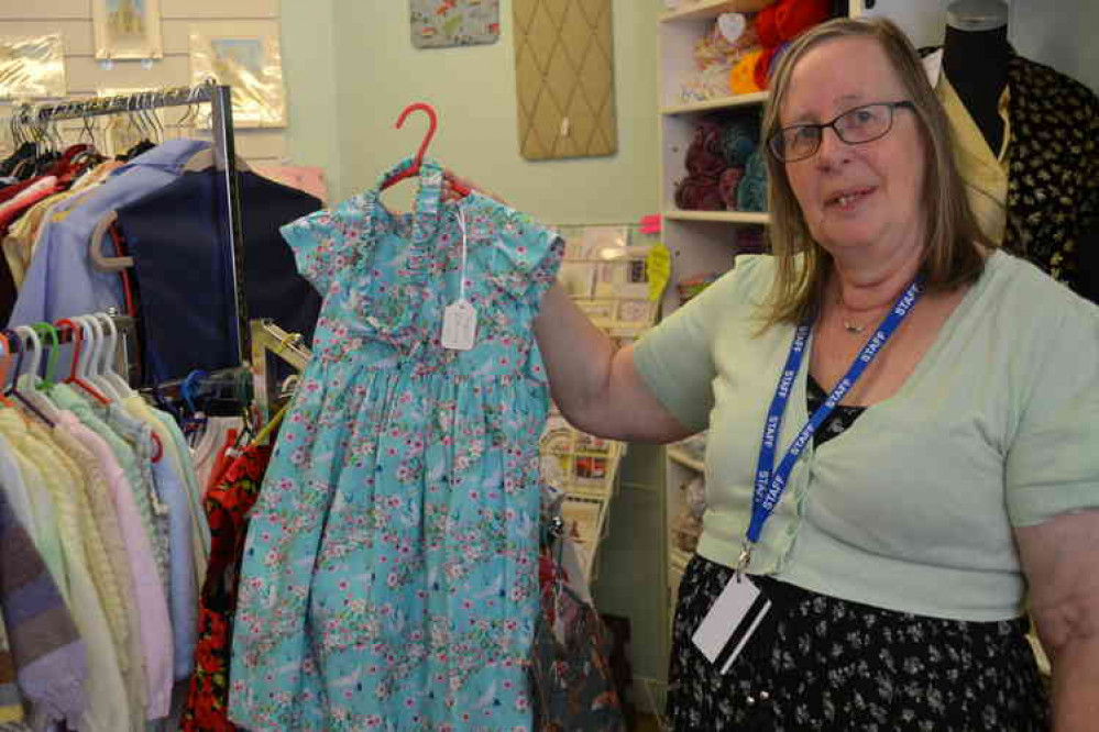 Chrissy Meadows with one of the charming girls' dresses handmade and for sale