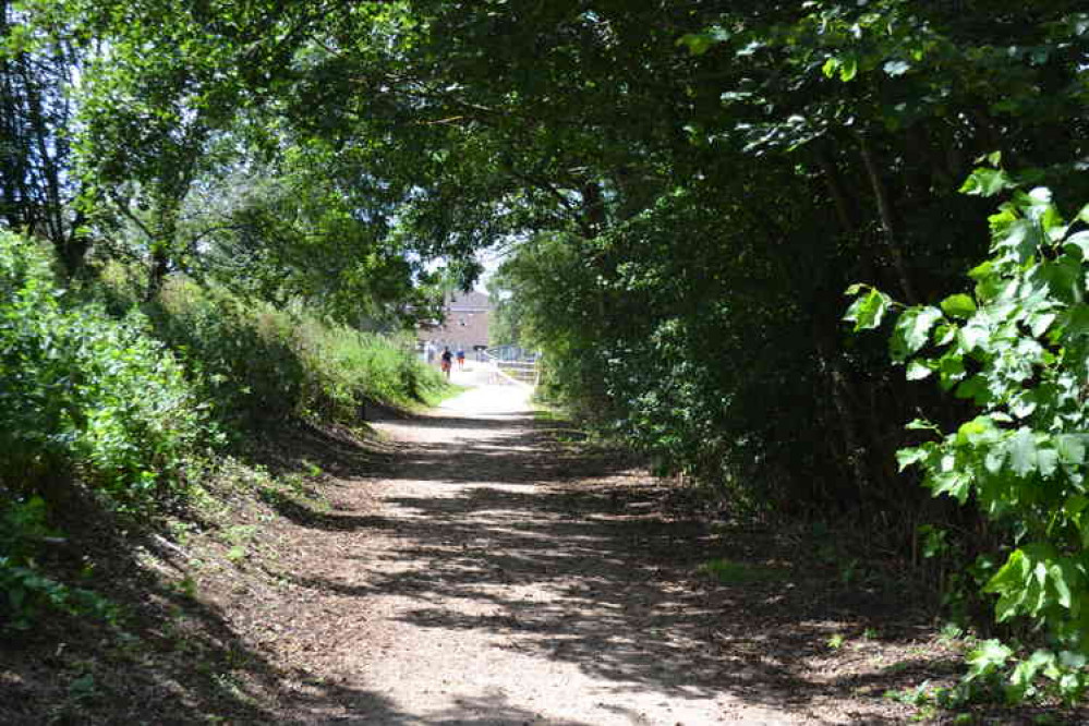 A family enjoys the river-side walk back towards the entrance