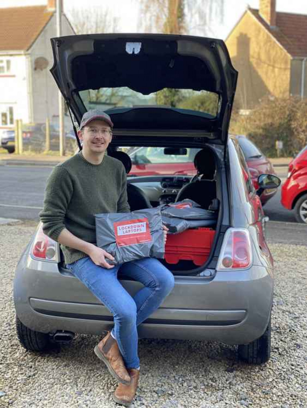 Cllr Grant Johnson with the Lockdown Laptop donation packages, which have all been collected and distributed out of the back of his small Fiat 500. Photo Credit: Laura Heal