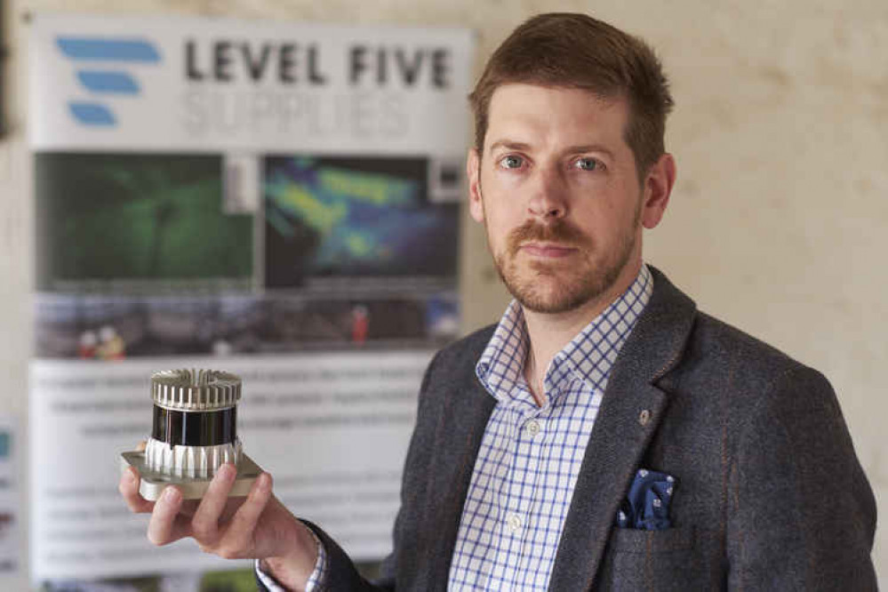 Alex Lawrence Berkeley CEO Level Five Supplies holding an Ouster LiDAR sensor