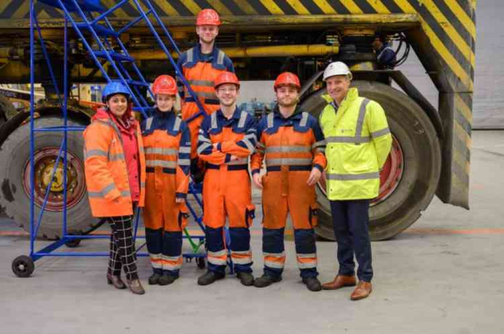 Maritime Minister Nusrat Ghani and Ernst Schulze, CEO DP World UK, with engineering apprentices from DP World London Gateway.