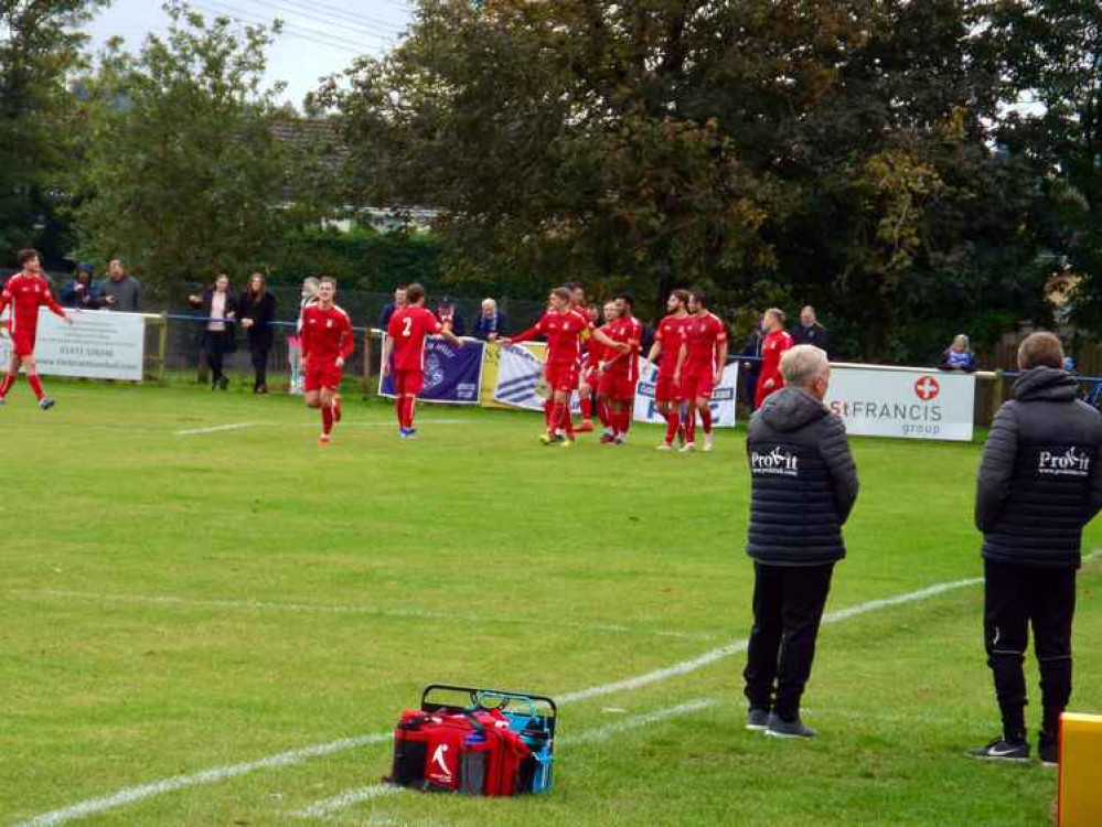 The management team of Keith Rowland and John Coventry look on as Millers celebrate their first goal in the 3-0 second qualifying round win at Brantham on Saturday.