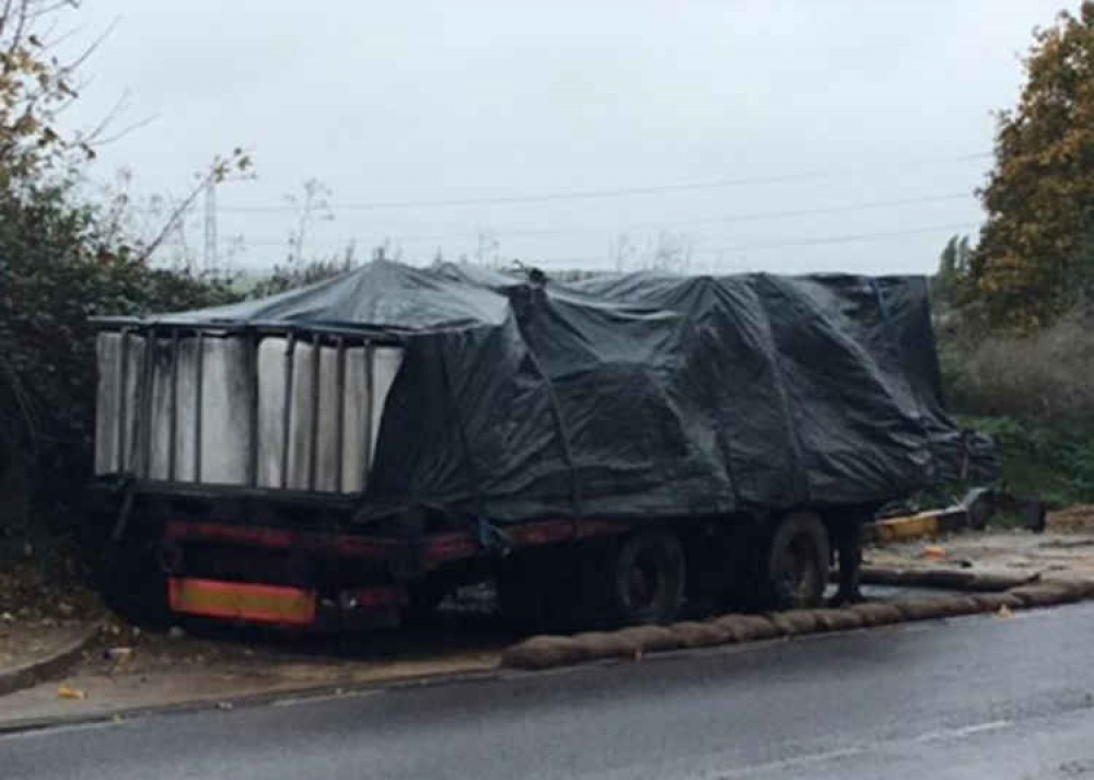 Hazardous waste has been left on this dumped trailer on Sandy Lane.