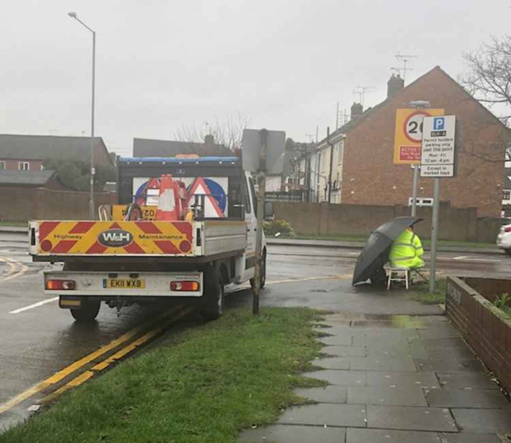 Hidden by his truck and an umbrella this worker's parking not only churned up a verge, he also blocked the view of drivers approaching the junction.