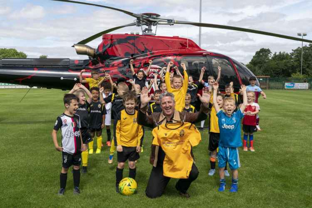 Community is key says Alfie Best, pictured with the club's young players on a visit to Rookery Hill by helicopter last year.