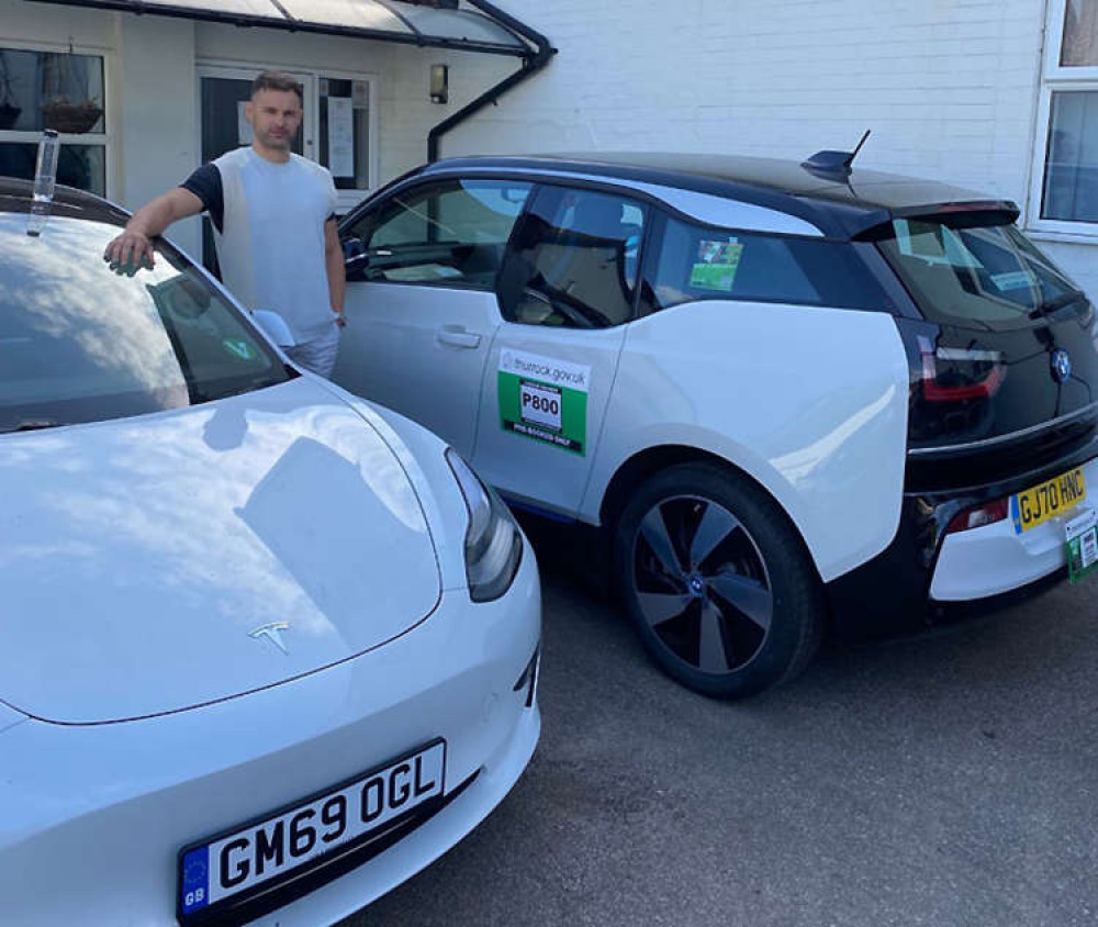 Dacian Keran with two vehicles from the BMW and Tesla fleet based at the company's HQ in Grays.