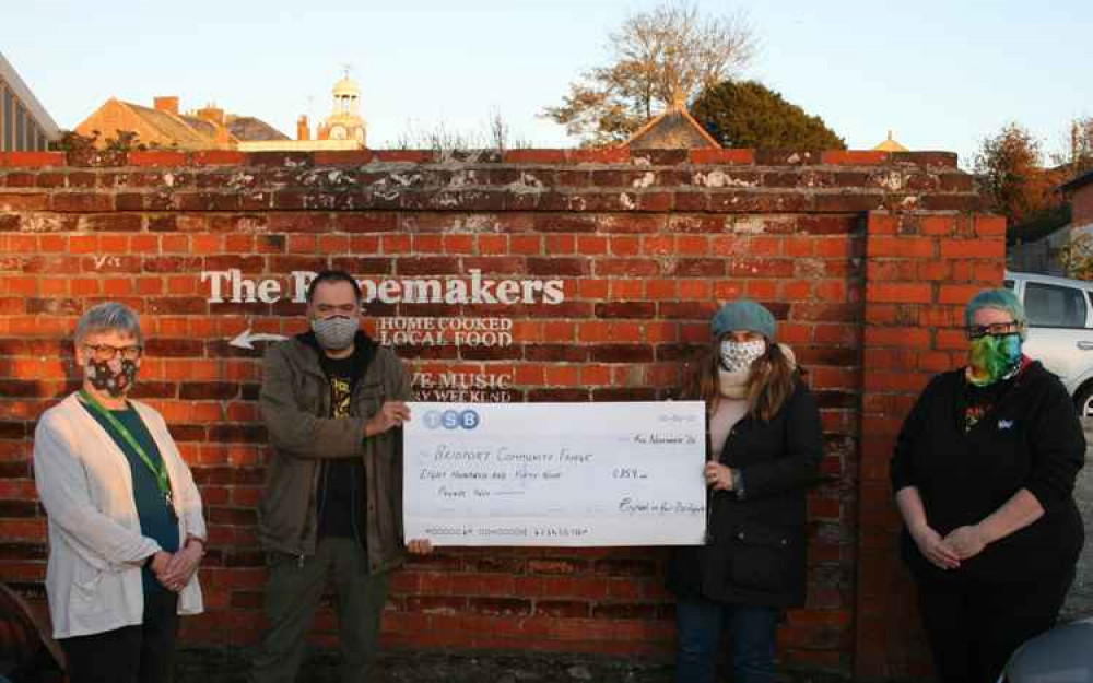 Geraldine Baker, Keith Hatch and Ruthy Ni Connallain presented Elizabeth Harley from Bridport Community Fridge with a cheque for £859