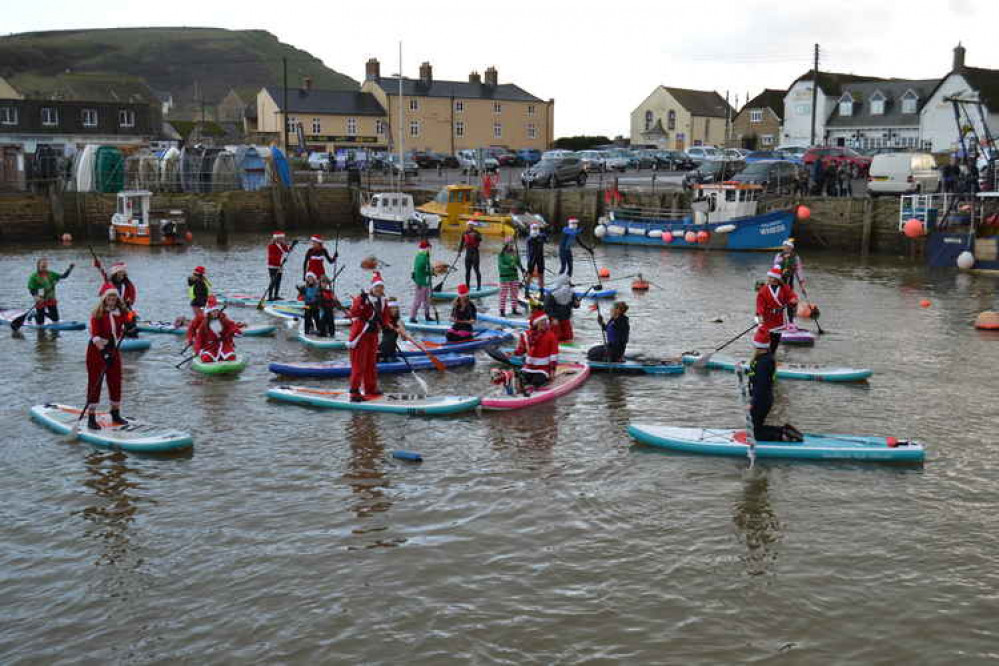 The Santa paddle boarders in West Bay harbour