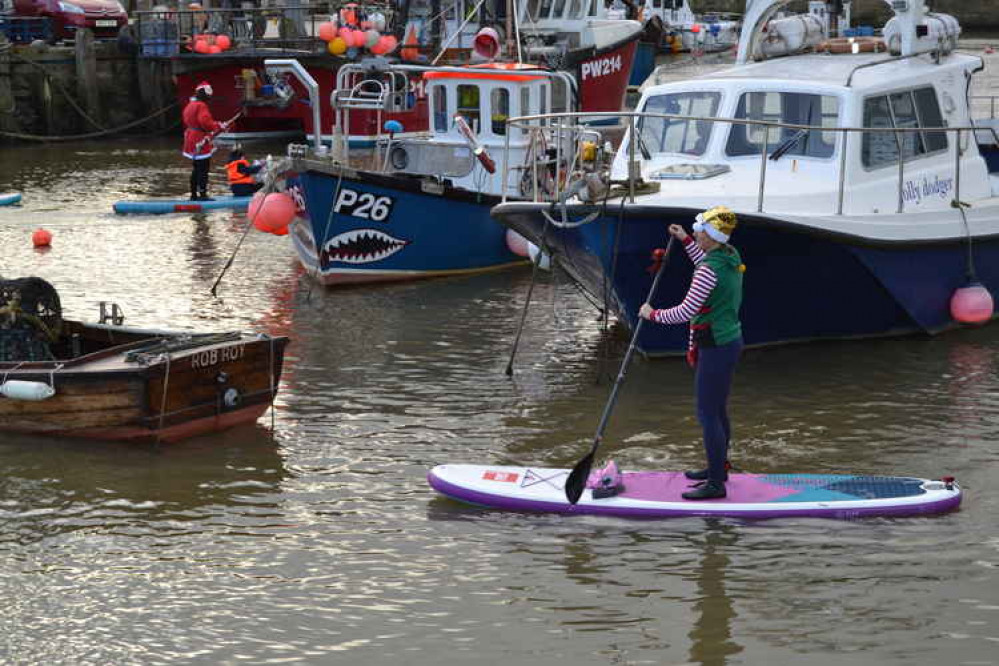 The Santa paddle boarders in West Bay harbour