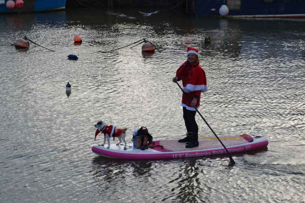 The Santa paddle boarders in West Bay harbour