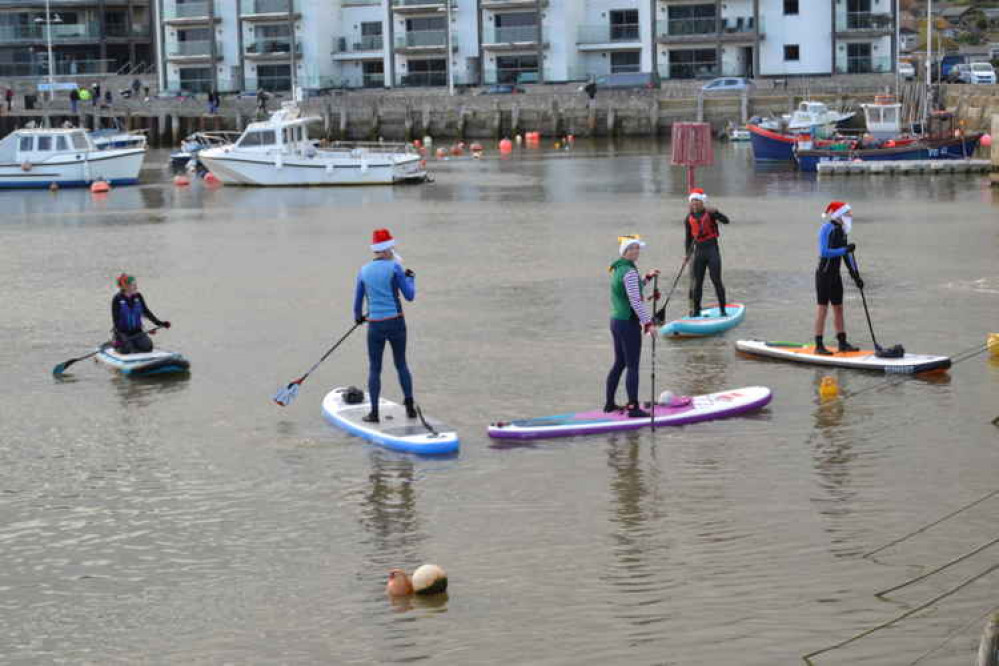 The Santa paddle boarders in West Bay harbour