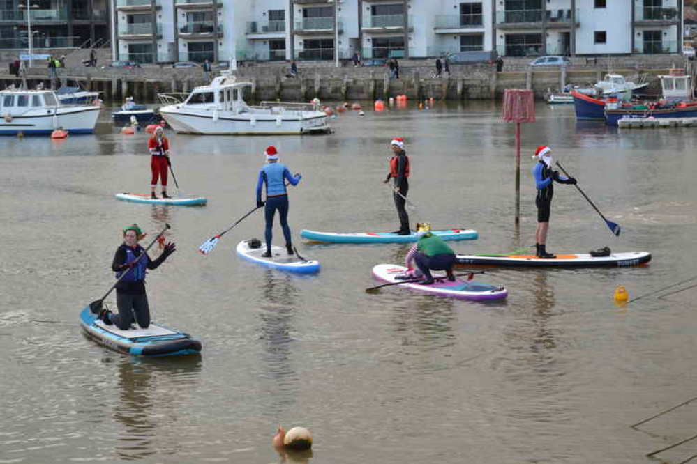 The Santa paddle boarders in West Bay harbour