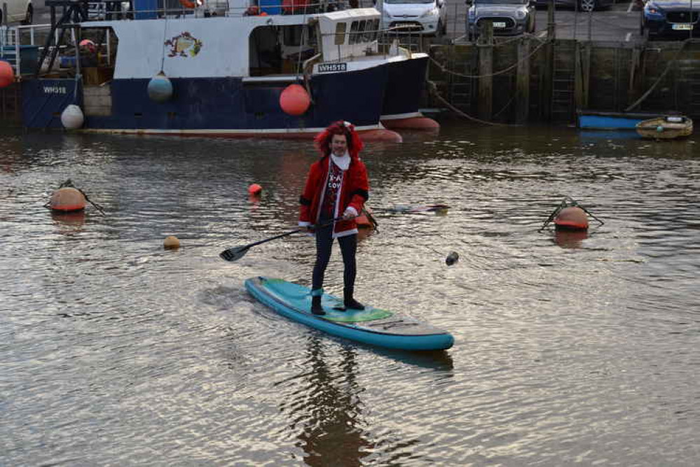 The Santa paddle boarders in West Bay harbour