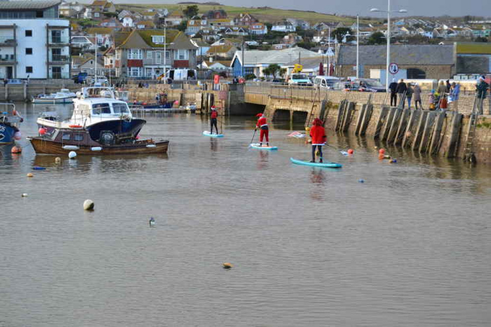 The Santa paddle boarders in West Bay harbour