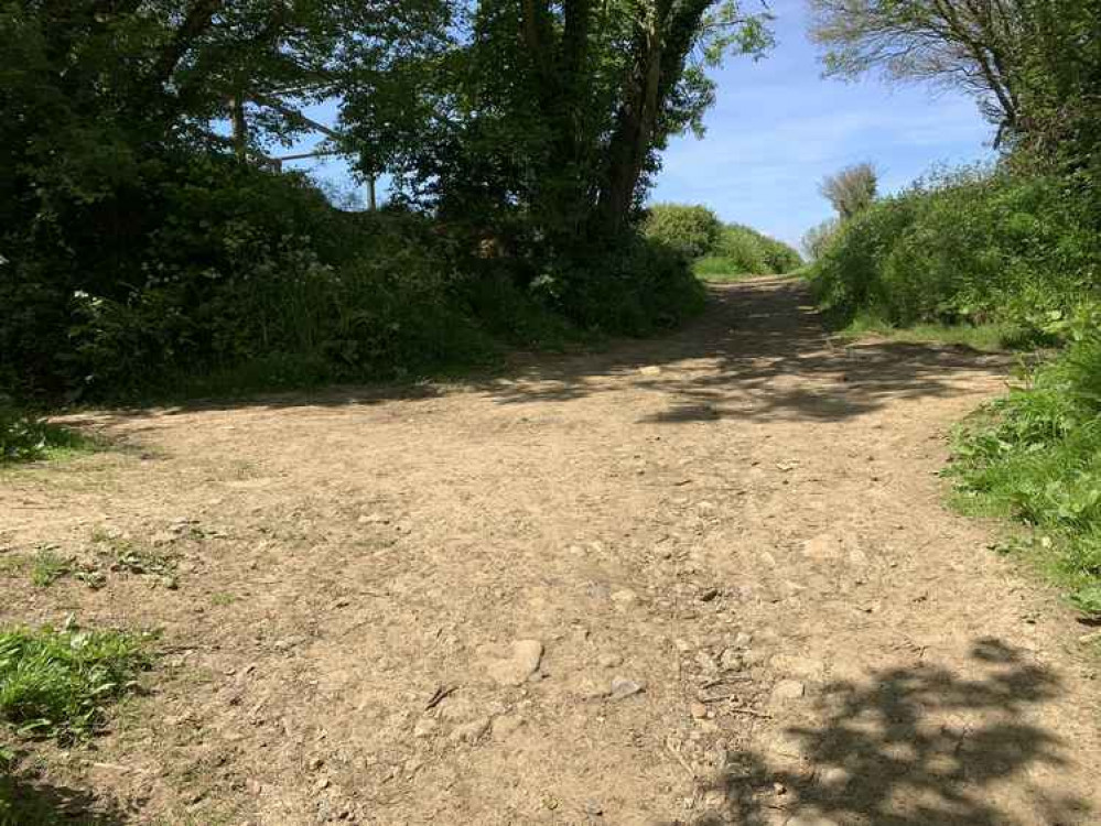 At the crossroads continue straight to go past a steel frame on your left