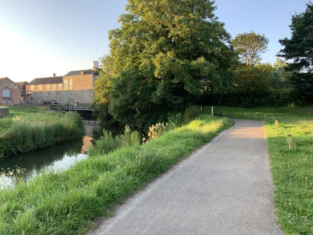 In the car park, take the footpath next to the river to the road