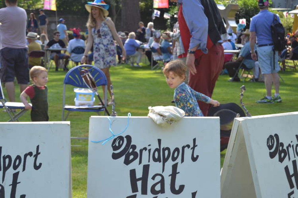 Two-year-old Edlyn Burton tries her hand at hat hurling