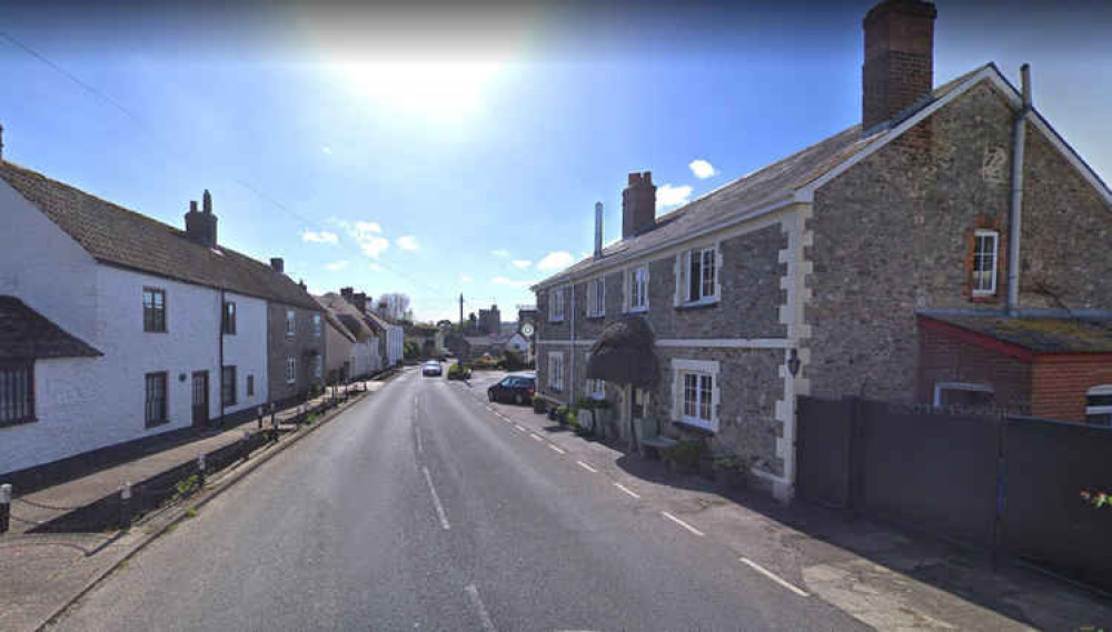 The main street through Axmouth where parish councillors are hoping to install vehicle activation signs to slow down traffic.