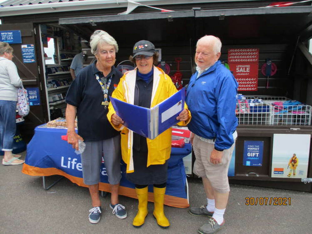 Wendy Cummins, secretary of the Beer & District RNLI branch, reads a poem to mark the reopening