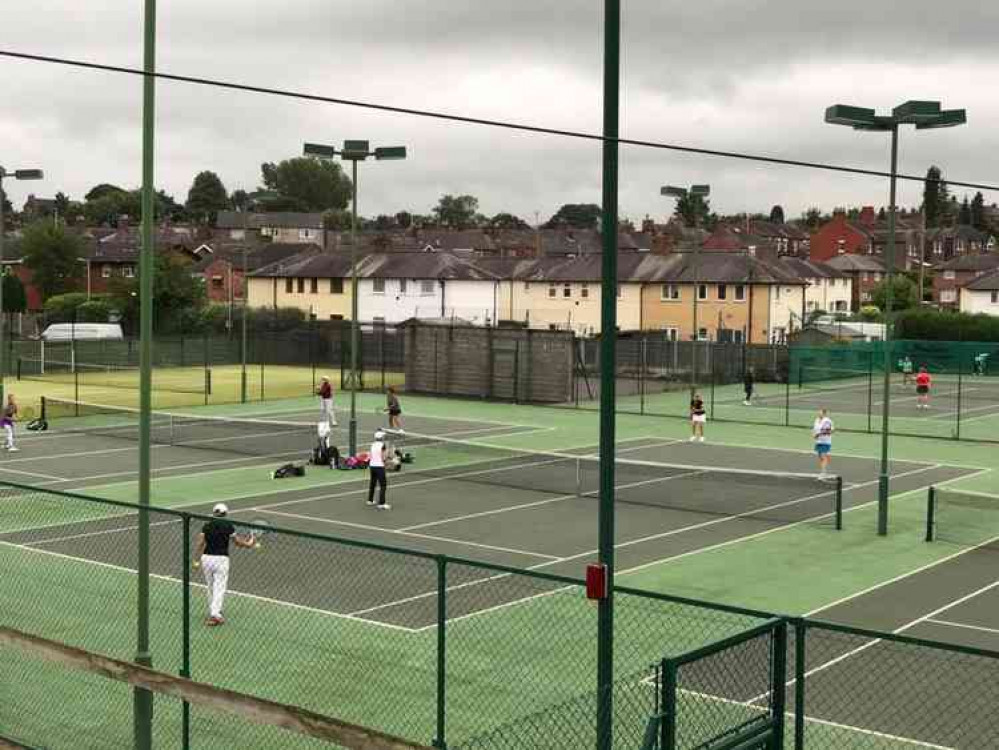 Players in action at the tennis club Players in action at the tennis club