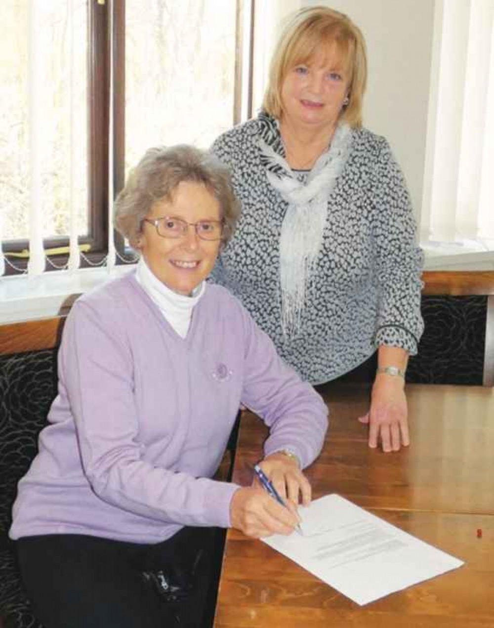 Lady captain Anita Pepper (standing) with lady vice-captain Linda Stevens.