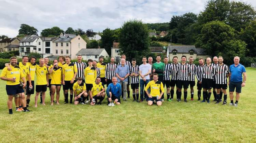 Owen and Les Bounds pictured centre with the teams from Uplyme Football Club and the local emergency services wearing a Lyme Regis kit (photo credit: Uplyme Football Club) Owen and Les Bounds pictured centre with the teams from Uplyme Football Club and the local emergency services wearing a Lyme Regis kit (photo credit: Uplyme Football Club)
