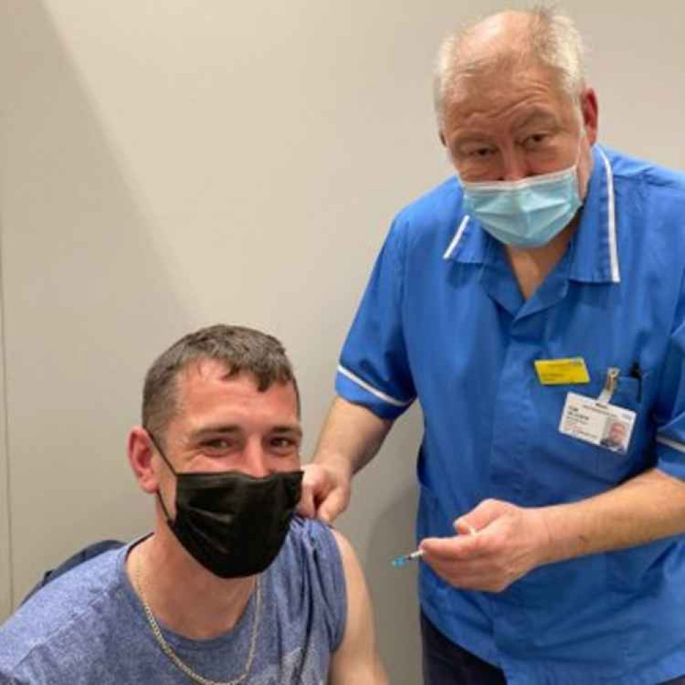 Carl from Macclesfield is all smiles, as he was the last to ever recieve an official jab from the Macclesfield Hospital team. (Image - East Cheshire NHS Trust)