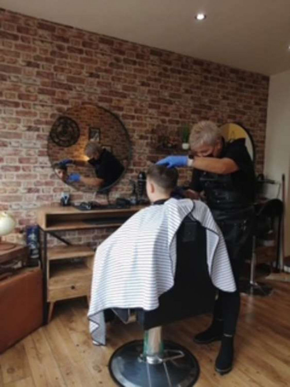 Steph cutting a customer's hair