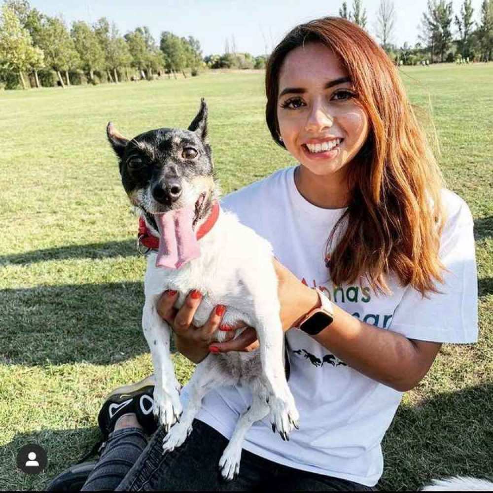 Staff member, Amy Sanchez and her very happy canine friend