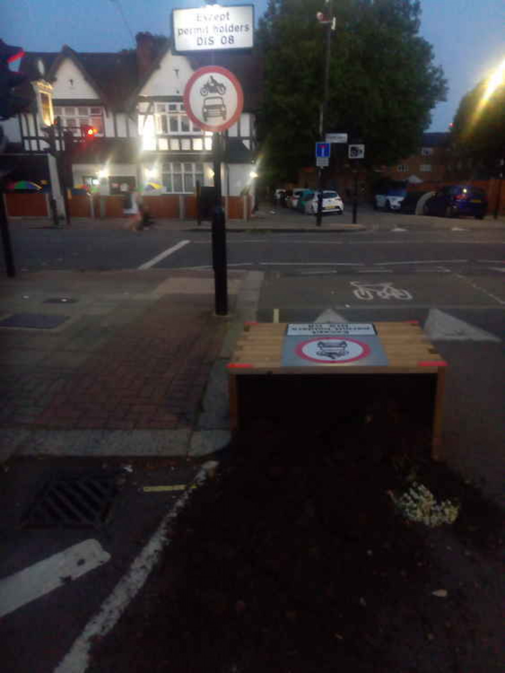 The plants and soil inside the planters have poured out all over the road. Image Credit: Marc Yonder