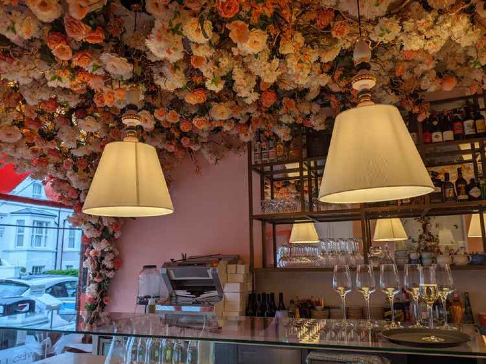 Gorgeous flowers line the ceiling above the bar. The restaurant's decor is inspired by Mayfair Club Annabel's (Image: Ellie Brown)