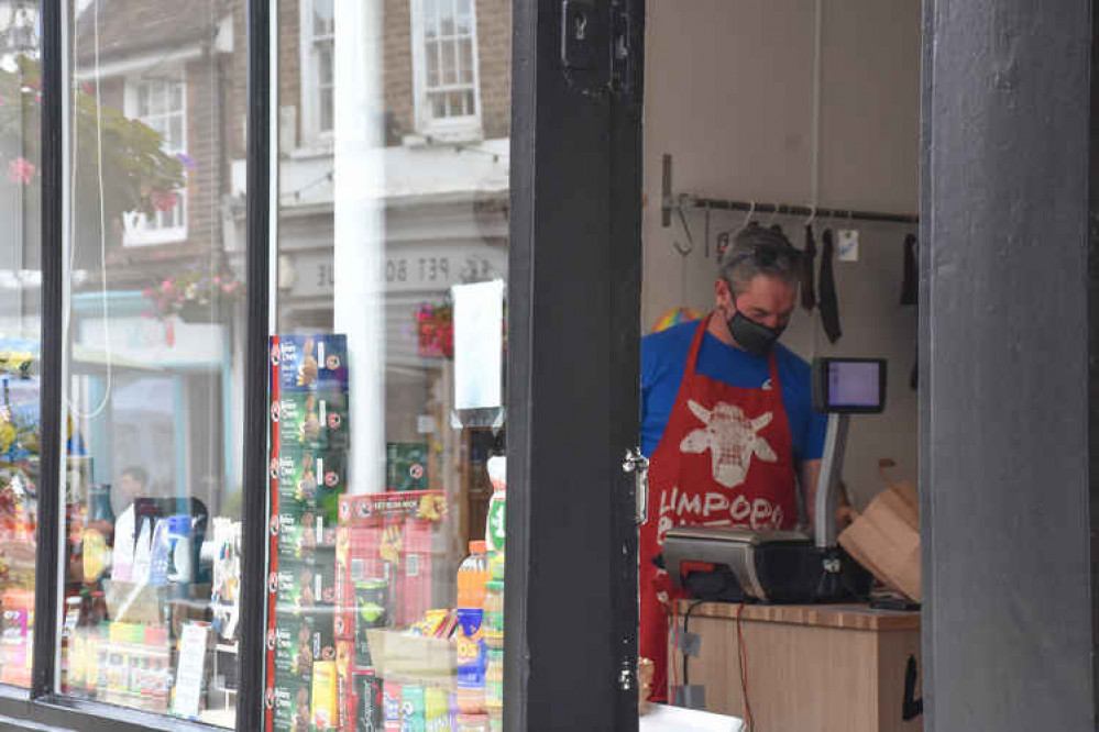 Pierre serving a customer in his new shop