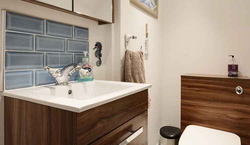 It features a fully-fitted modern bathroom