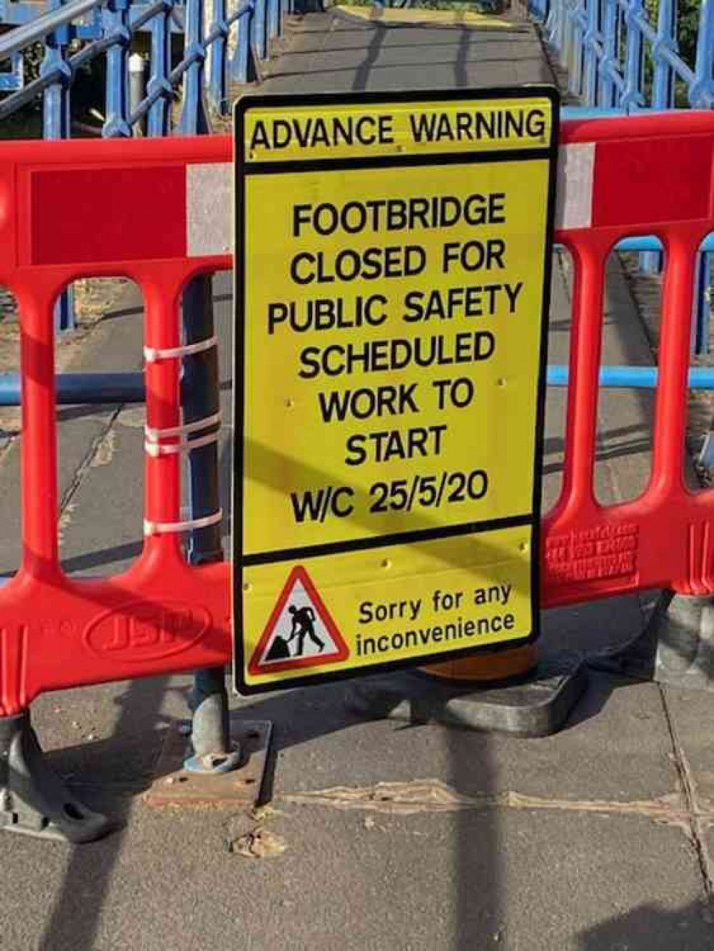 Warning sign and barrier stopping entry to bridge