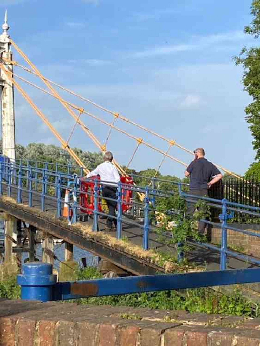 Two men, said to be council engineers, on their mobile phones