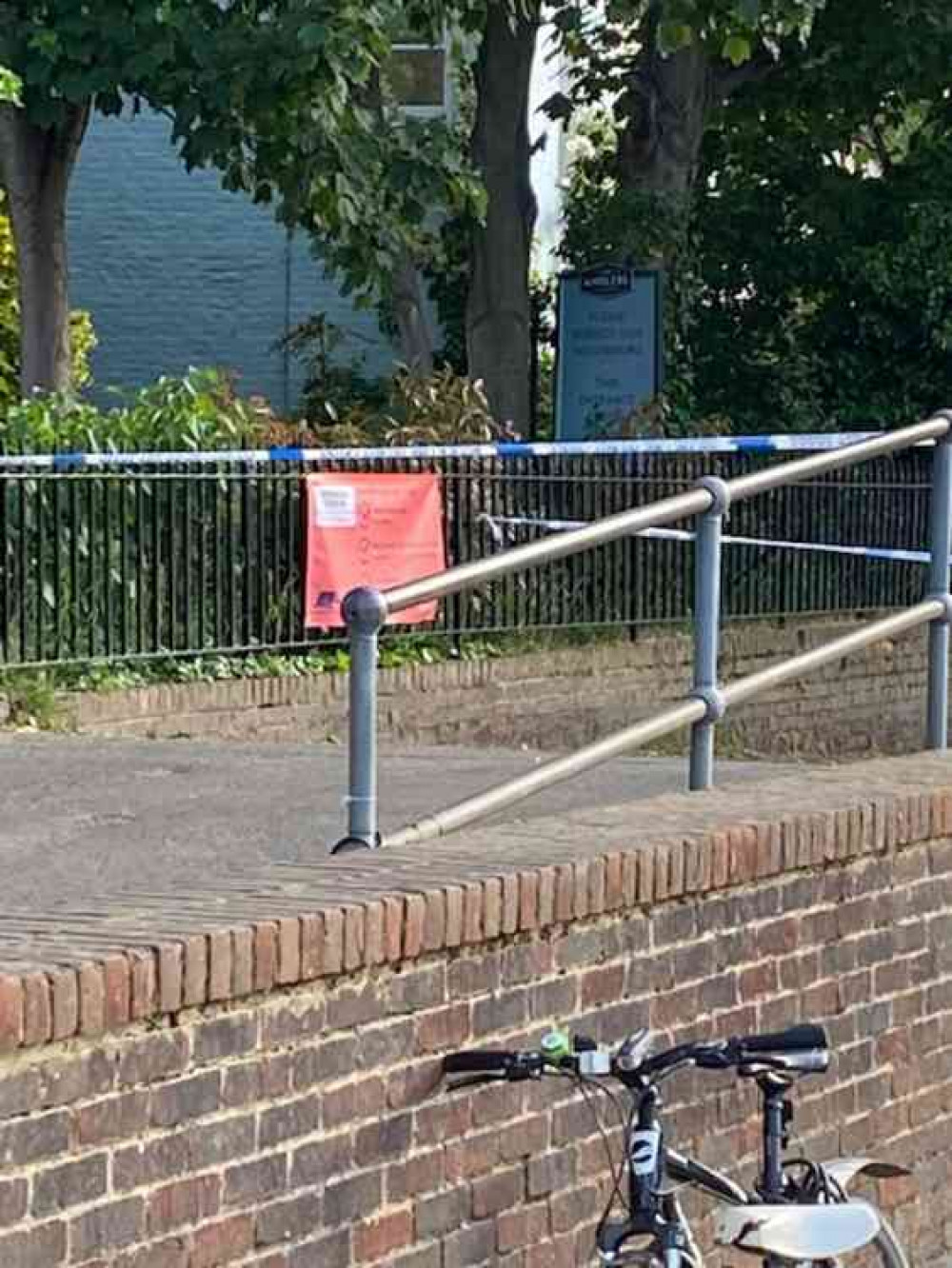 Blue and white police tape cordons off the bridge